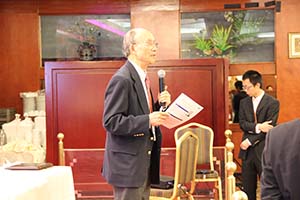 Aged Chinese national announcing the Scholarship Winner during the Annual Conference Workshop Meeting